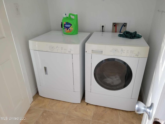 clothes washing area with washer and clothes dryer