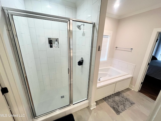 bathroom with tile patterned floors, ornamental molding, and shower with separate bathtub