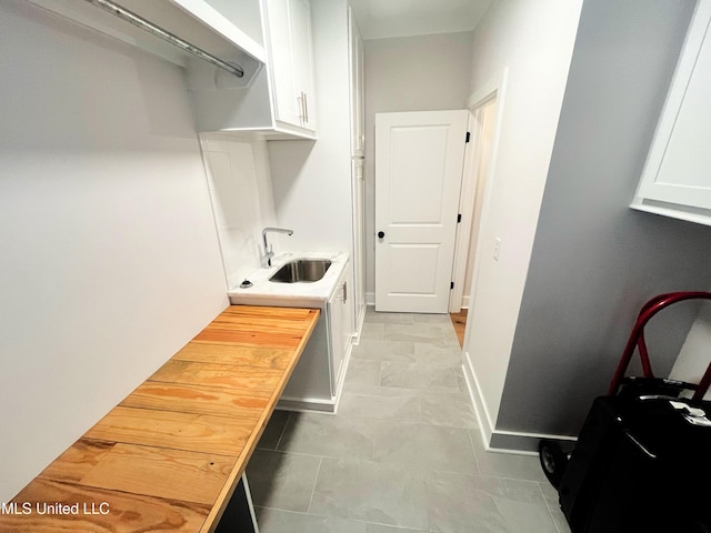 clothes washing area with sink