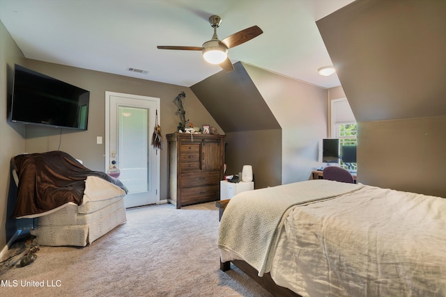 carpeted bedroom featuring ceiling fan, vaulted ceiling, and visible vents