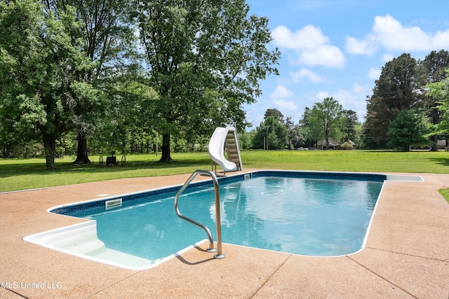 outdoor pool with a lawn and a water slide