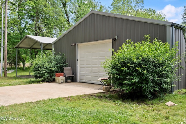 garage featuring driveway and a detached garage
