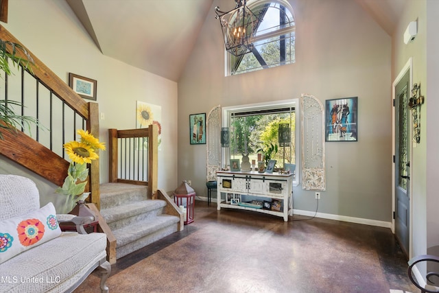 sitting room with a healthy amount of sunlight, high vaulted ceiling, baseboards, and stairs