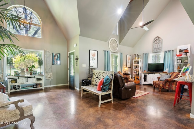 living room featuring high vaulted ceiling, baseboards, and concrete flooring