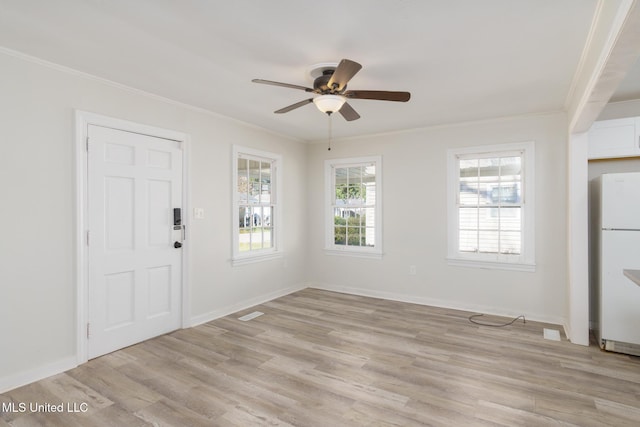 foyer with ceiling fan, ornamental molding, light wood-type flooring, and baseboards