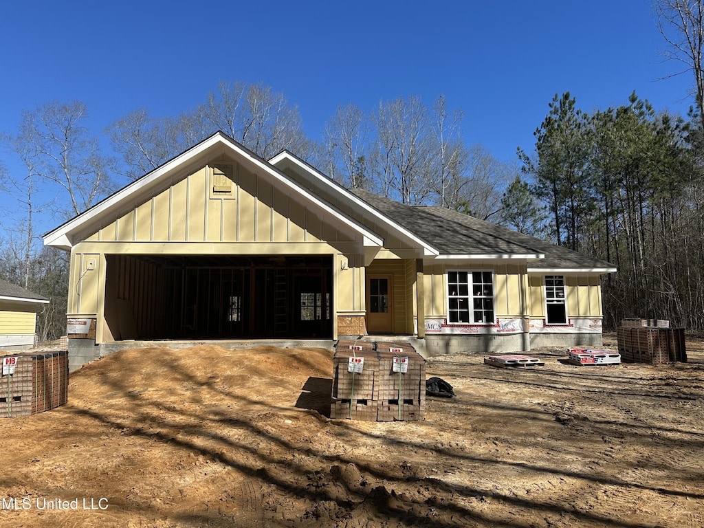 view of front of property with an attached garage, driveway, and board and batten siding