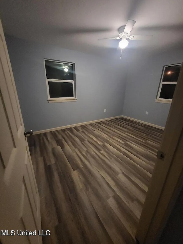 unfurnished bedroom with wood finished floors, a ceiling fan, and baseboards