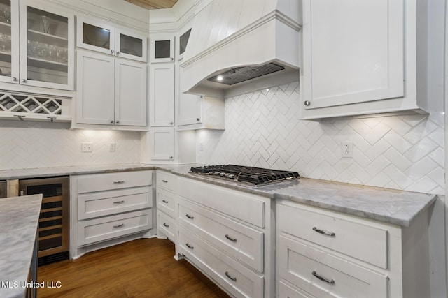 123 Klaas Blvd, Madison, MS 39110 - kitchen featuring wine cooler, custom range hood, white cabinets, and tasteful backsplash