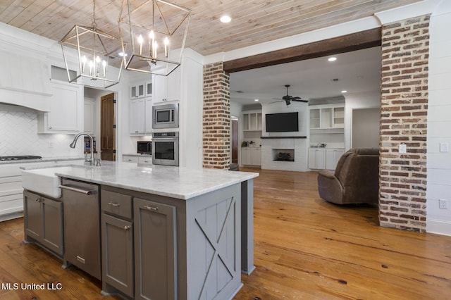 123 Klaas Blvd, Madison, MS 39110 - kitchen with stainless steel appliances, gray cabinets, hardwood / wood-style flooring, white cabinets, and ceiling fan