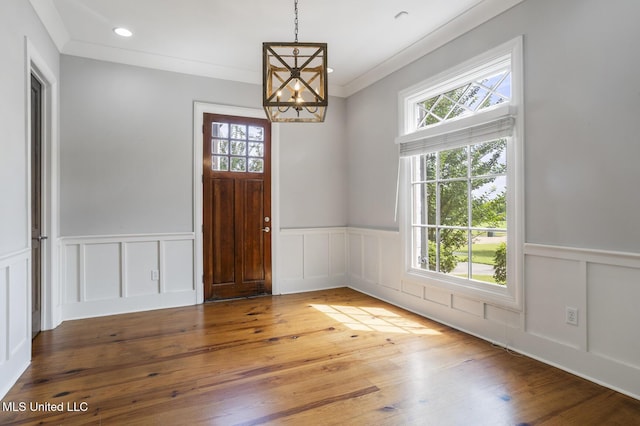 123 Klaas Blvd, Madison, MS 39110 - entrance foyer with a chandelier, a wainscoted wall, a decorative wall, and wood finished floors