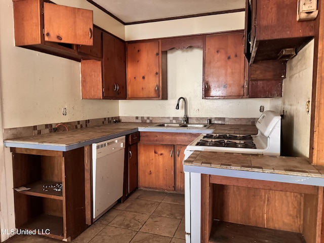 341 Savanna St, Jackson, MS 39212 - kitchen featuring white appliances, brown cabinets, a sink, and tile patterned floors
