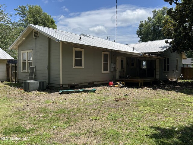 1006 Lamar St, Cleveland, MS 38732 - rear view of property featuring a yard, central air condition unit, metal roof, and a deck