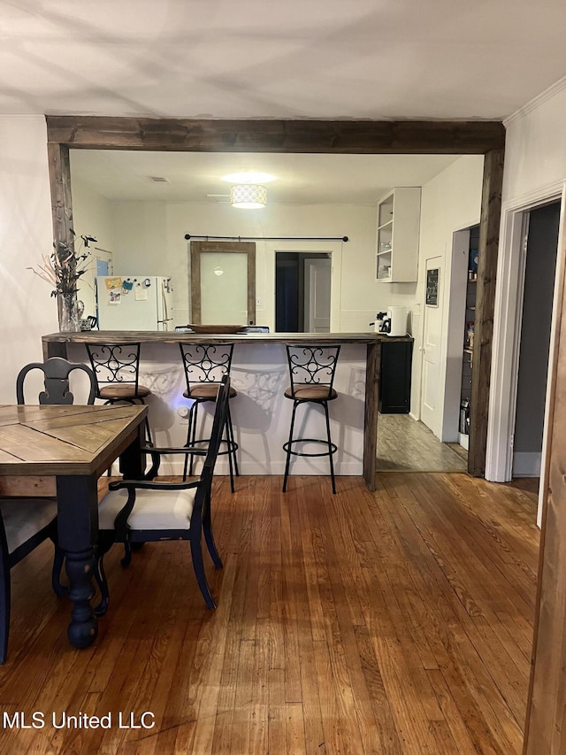 1006 Lamar St, Cleveland, MS 38732 - dining room with dark wood finished floors, beamed ceiling, and crown molding
