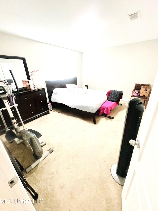 bedroom with visible vents and carpet