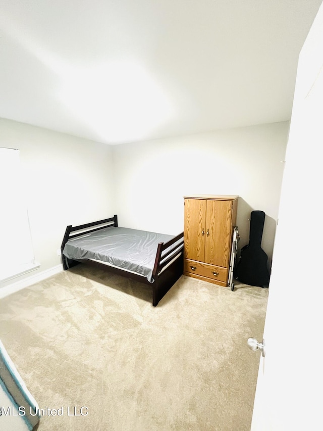 bedroom with light colored carpet