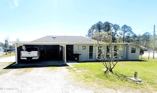 ranch-style home featuring a front lawn, driveway, and an attached carport