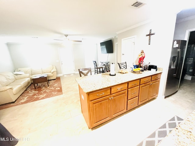 kitchen featuring visible vents, a peninsula, crown molding, open floor plan, and stainless steel fridge with ice dispenser