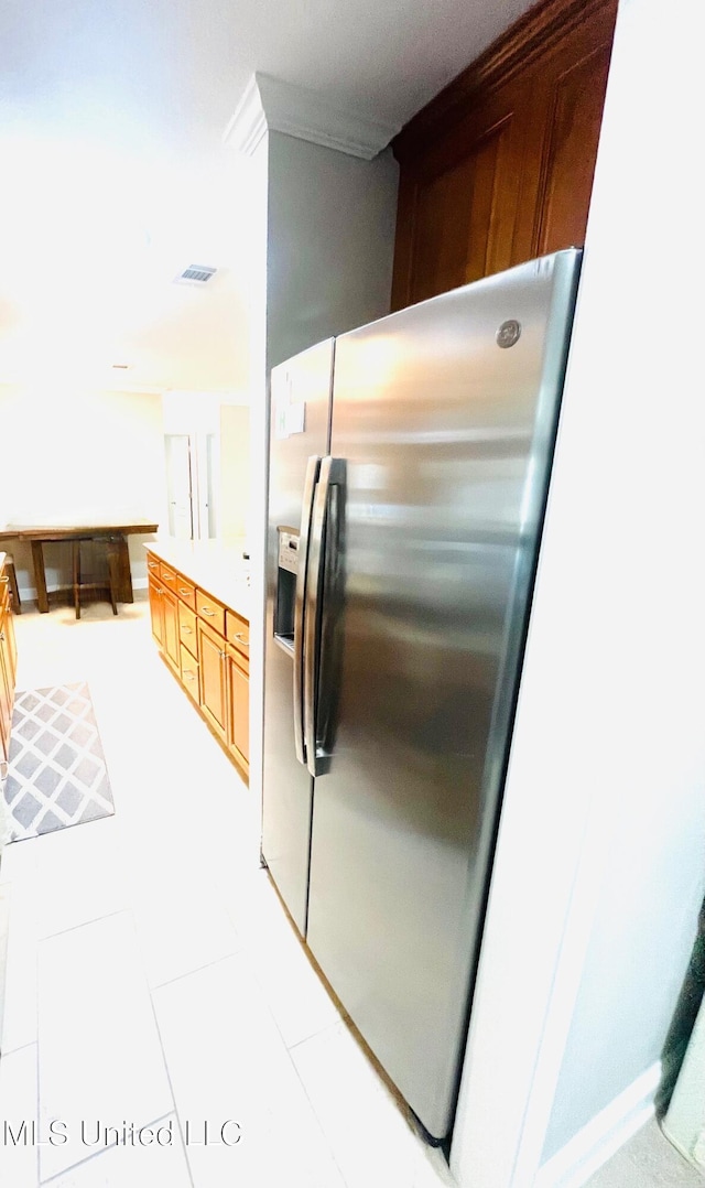 kitchen featuring visible vents and stainless steel fridge