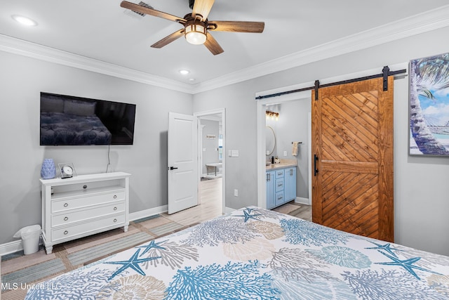 bedroom with ornamental molding, a barn door, ceiling fan, and ensuite bathroom