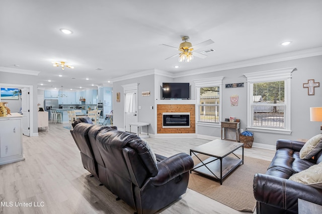 living room featuring ornamental molding, ceiling fan, and light wood-type flooring