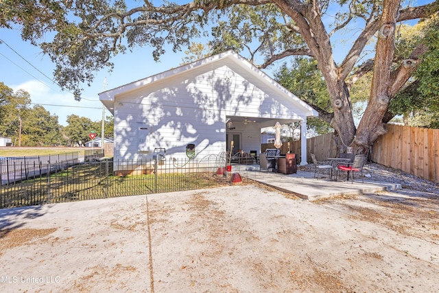 rear view of house with a yard and a patio