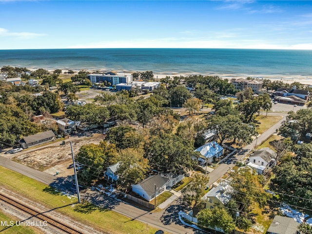 birds eye view of property with a water view and a beach view