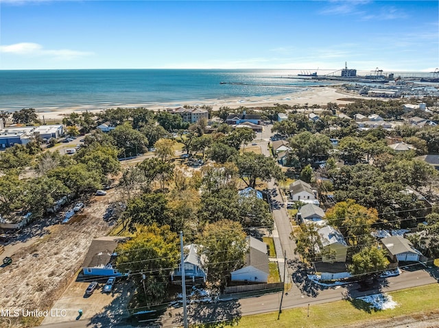 birds eye view of property with a water view and a beach view