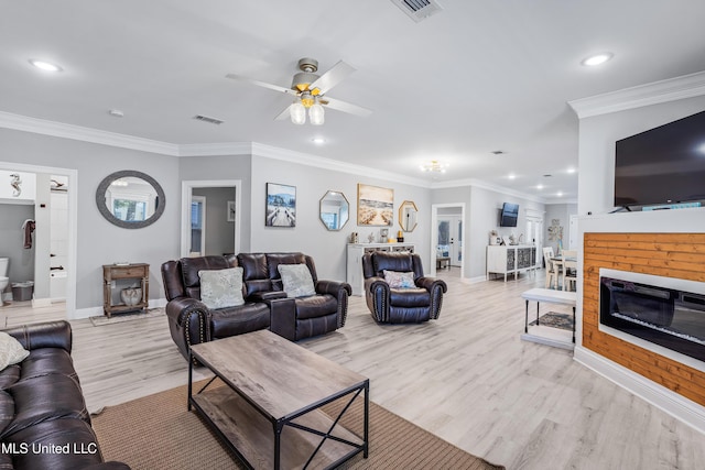 living room featuring ornamental molding, ceiling fan, and light hardwood / wood-style flooring