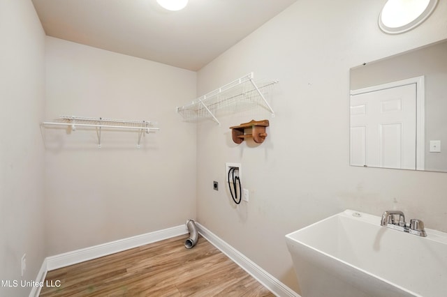 14540 Canal Loop, Gulfport, MS 39503 - washroom featuring wood finished floors, baseboards, washer hookup, and hookup for an electric dryer