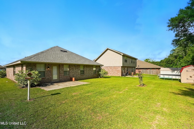 14540 Canal Loop, Gulfport, MS 39503 - back of property with a patio, a yard, brick siding, and a shed