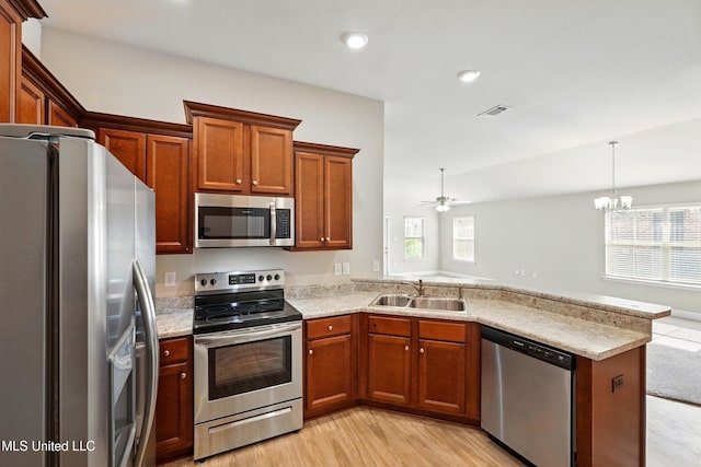 14540 Canal Loop, Gulfport, MS 39503 - kitchen featuring stainless steel appliances, a peninsula, light wood finished floors, healthy amount of natural light, and recessed lighting