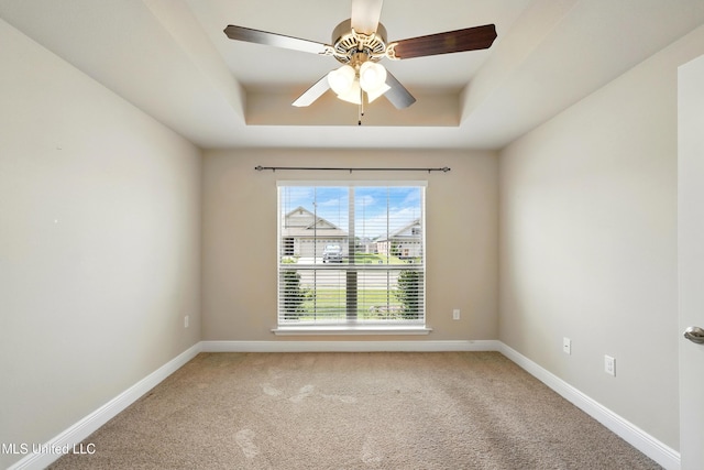 14540 Canal Loop, Gulfport, MS 39503 - unfurnished room featuring a tray ceiling, carpet floors, baseboards, and a ceiling fan