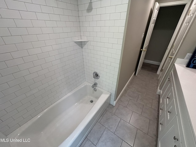 215 Quail Trl, Greenwood, MS 38930 - full bath featuring tile patterned floors, tub / shower combination, and baseboards