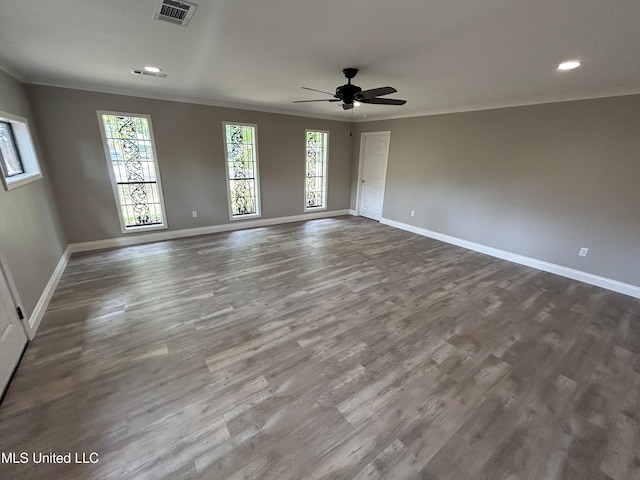 215 Quail Trl, Greenwood, MS 38930 - unfurnished room with crown molding, baseboards, dark wood-style floors, a ceiling fan, and recessed lighting