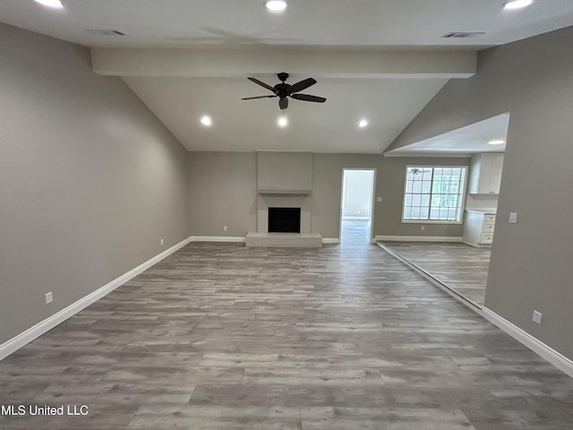 215 Quail Trl, Greenwood, MS 38930 - unfurnished living room featuring baseboards, ceiling fan, wood finished floors, a fireplace, and recessed lighting