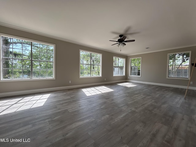 215 Quail Trl, Greenwood, MS 38930 - spare room featuring crown molding, baseboards, dark wood-style floors, and ceiling fan