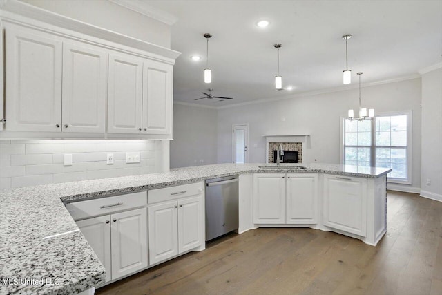 kitchen featuring light hardwood / wood-style flooring, sink, stainless steel dishwasher, white cabinets, and tasteful backsplash