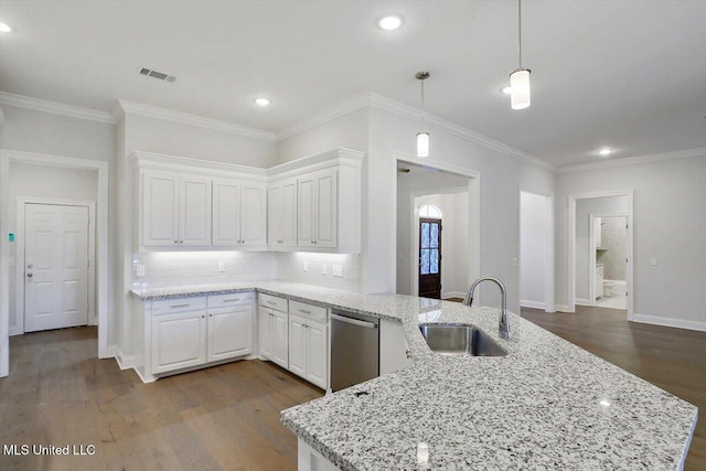 kitchen with stainless steel dishwasher, white cabinetry, hardwood / wood-style flooring, and sink