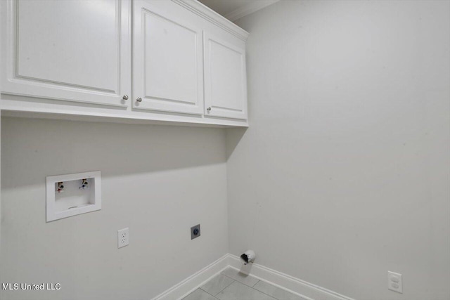 laundry area with hookup for an electric dryer, light tile patterned flooring, washer hookup, and cabinets