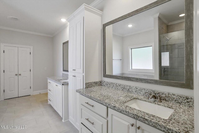 bathroom with vanity, crown molding, a shower with shower door, and tile patterned floors