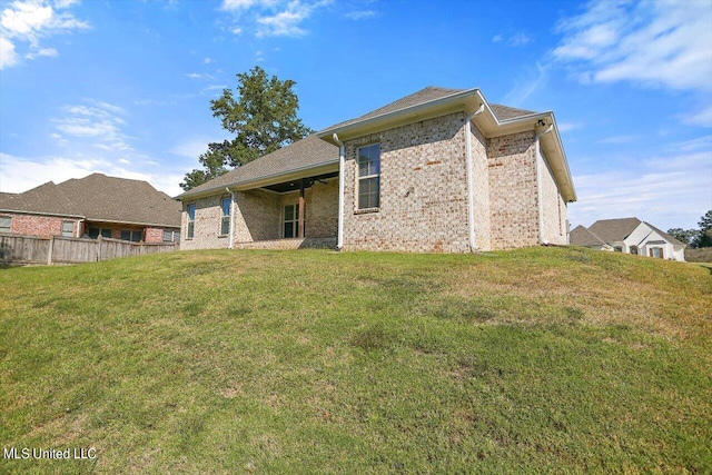 rear view of house with a lawn