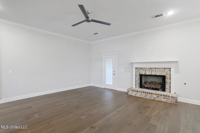 unfurnished living room with crown molding, dark wood-type flooring, and a fireplace