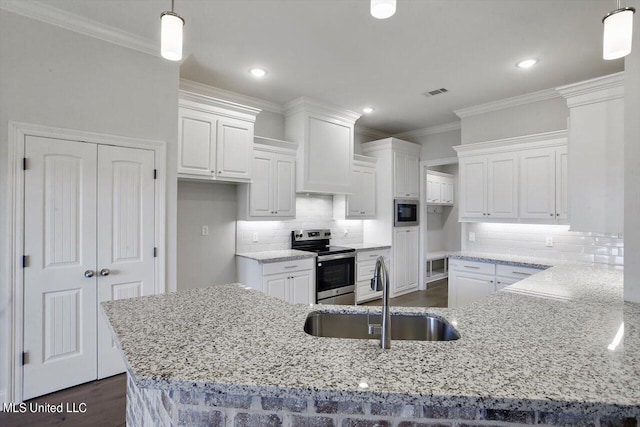 kitchen featuring white cabinetry, stainless steel appliances, sink, and pendant lighting