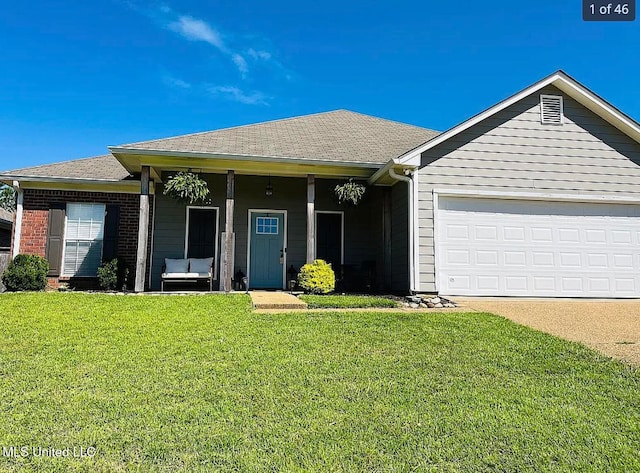 single story home featuring a garage, covered porch, and a front yard