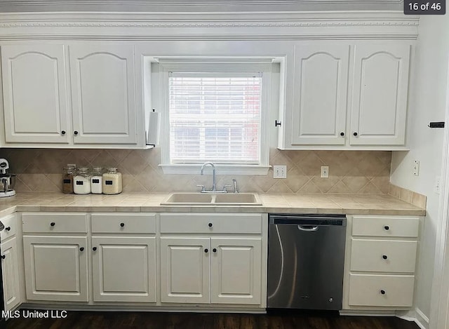 kitchen with dark wood-type flooring, white cabinetry, stainless steel dishwasher, and sink