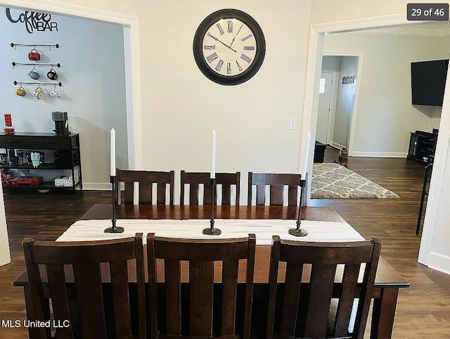 dining space with dark hardwood / wood-style flooring