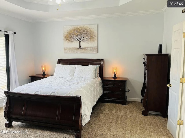 bedroom with a tray ceiling, light colored carpet, and ornamental molding