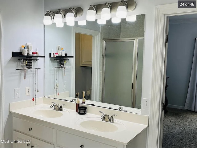 bathroom with vanity and a shower with door