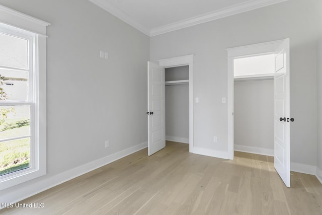 111 Grand Oak Blvd, Clinton, MS 39056 - unfurnished bedroom with ornamental molding, light wood-style floors, multiple closets, multiple windows, and baseboards
