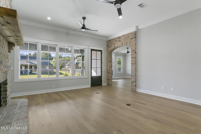 111 Grand Oak Blvd, Clinton, MS 39056 - unfurnished living room with a ceiling fan, a brick fireplace, wood finished floors, ornamental molding, and baseboards